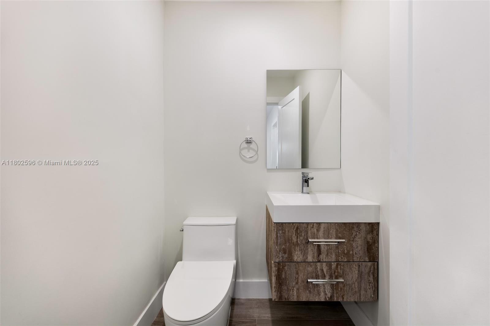 2478 Inagua Avenue Coconut Grove, FL 33133 - Photo 26 of 40 a bathroom with a toilet a sink and mirror