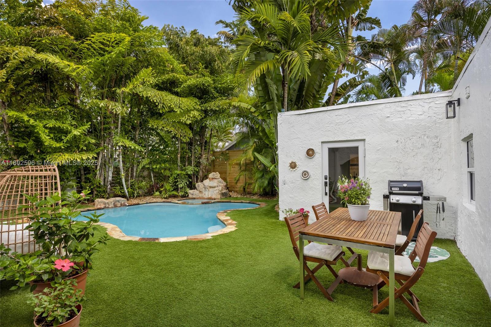 2478 Inagua Avenue Coconut Grove, FL 33133 - Photo 29 of 40 a view of a backyard with table and chairs and potted plants