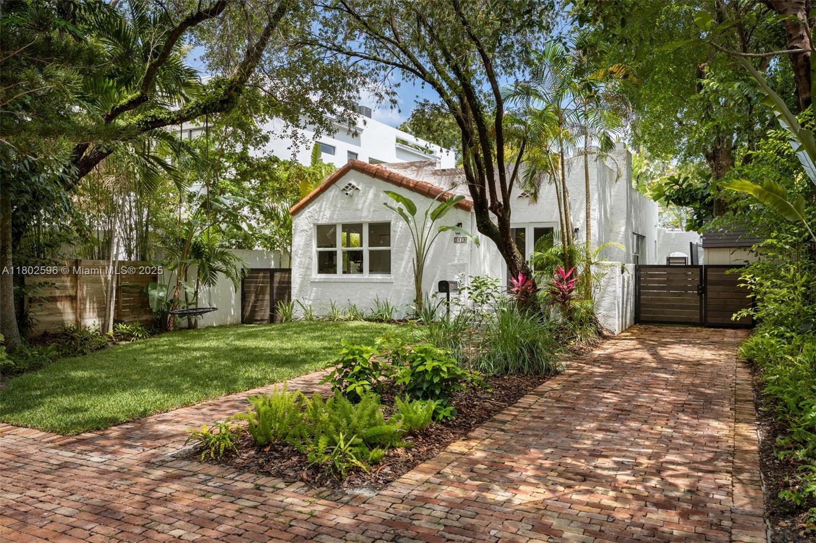 2478 Inagua Avenue Coconut Grove, FL 33133 - Photo 3 of 40 a front view of a house with a garden
