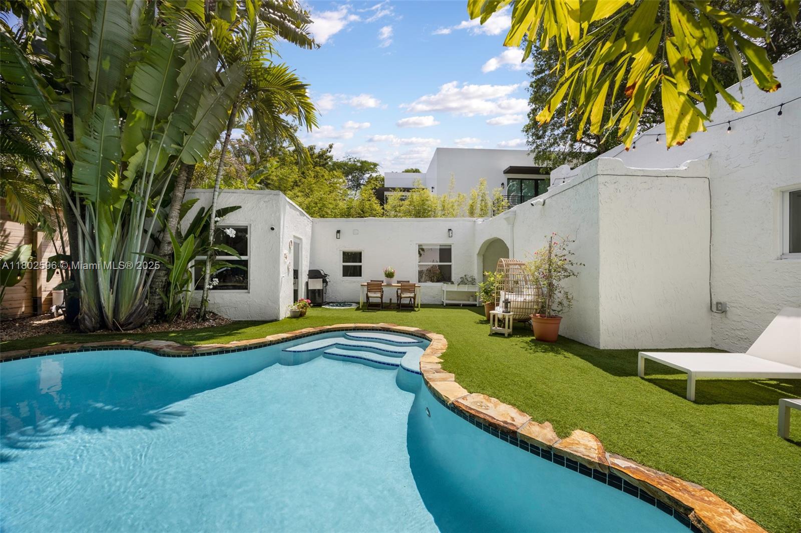 2478 Inagua Avenue Coconut Grove, FL 33133 - Photo 31 of 40 a view of swimming pool with a garden and trees