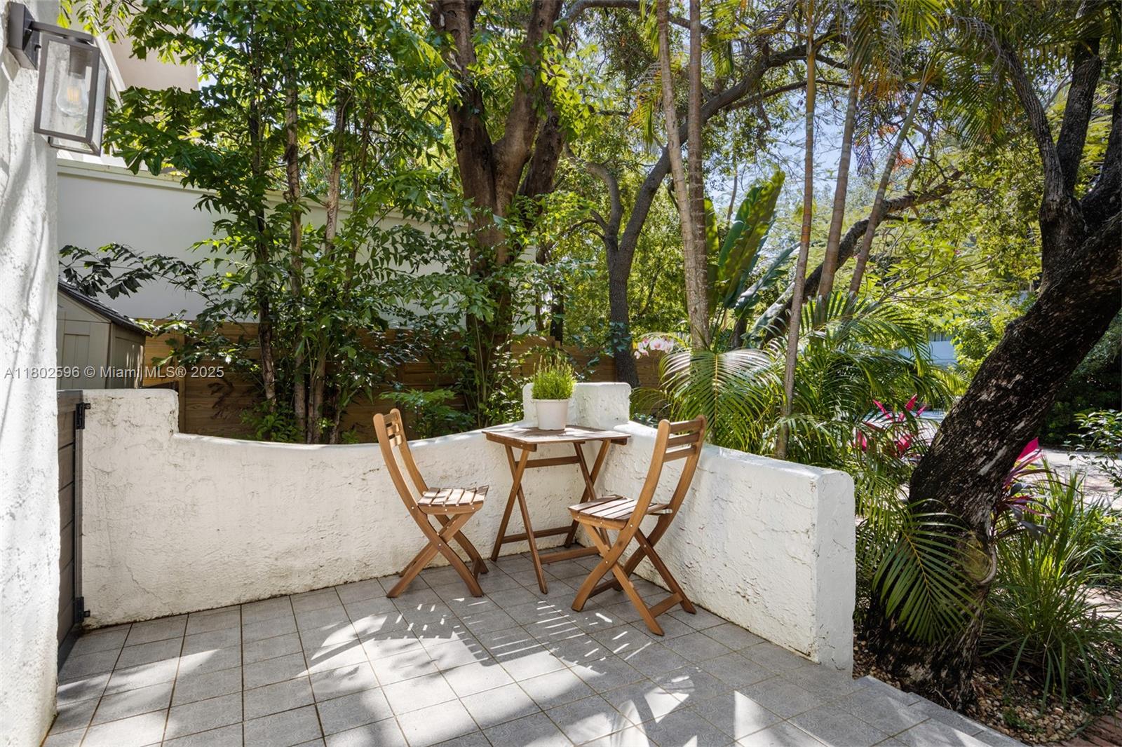 2478 Inagua Avenue Coconut Grove, FL 33133 - Photo 34 of 40 a view of a chairs and table in backyard