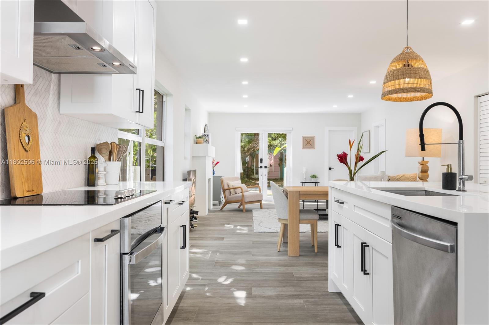2478 Inagua Avenue Coconut Grove, FL 33133 - Photo 9 of 40 a kitchen with white cabinets and sink