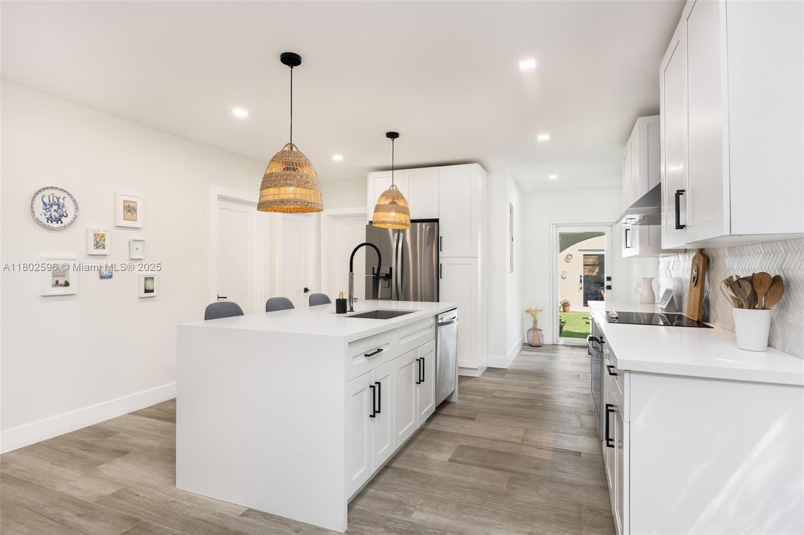 2478 Inagua Avenue Coconut Grove, FL 33133 - Photo 10 of 40 a large kitchen with kitchen island a stove a sink a refrigerator and a refrigerator