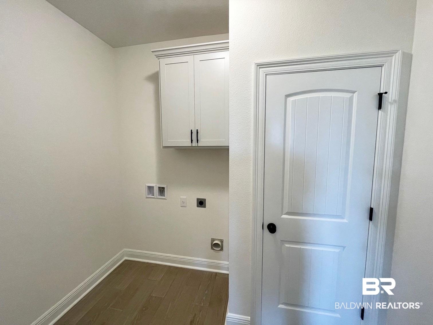 1339 Fenton Circle Foley, AL 36535 - Photo 14 of 17 Clothes washing area featuring washer hookup, electric dryer hookup, baseboards, dark wood-style flooring, and cabinet space
