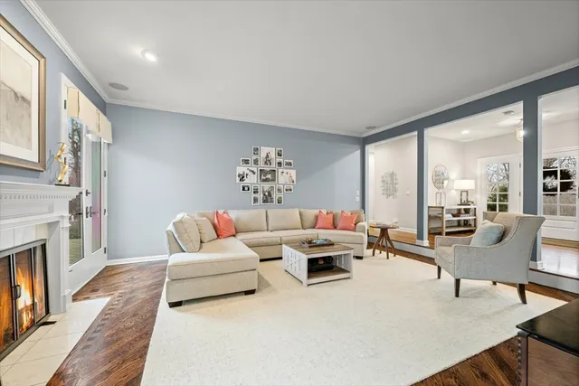 a living room with furniture large window and a fireplace