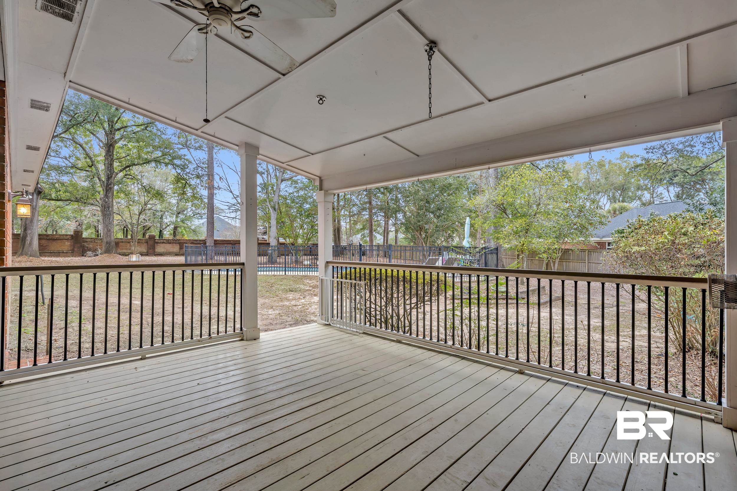 2858 Postoak Circle Mobile, AL 36693 - Photo 9 of 32 Deck featuring a fenced backyard and a swimming pool