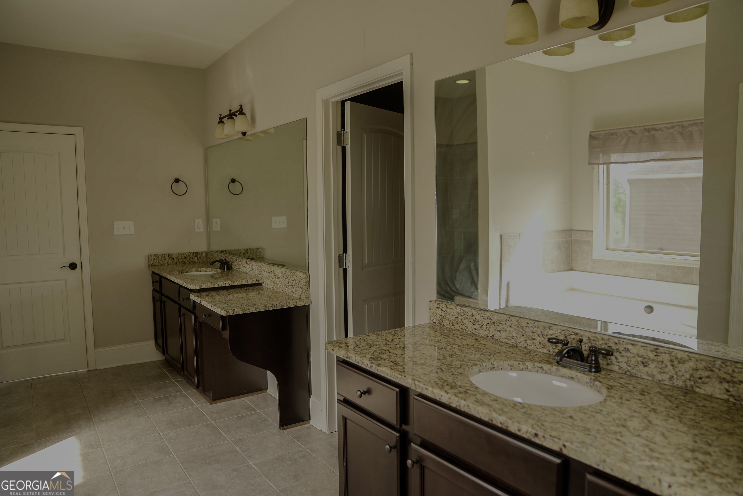 505 Mirror Lake Parkway Villa Rica, GA 30180 - Photo 13 of 28 a bathroom with a granite countertop sink a mirror and a shower