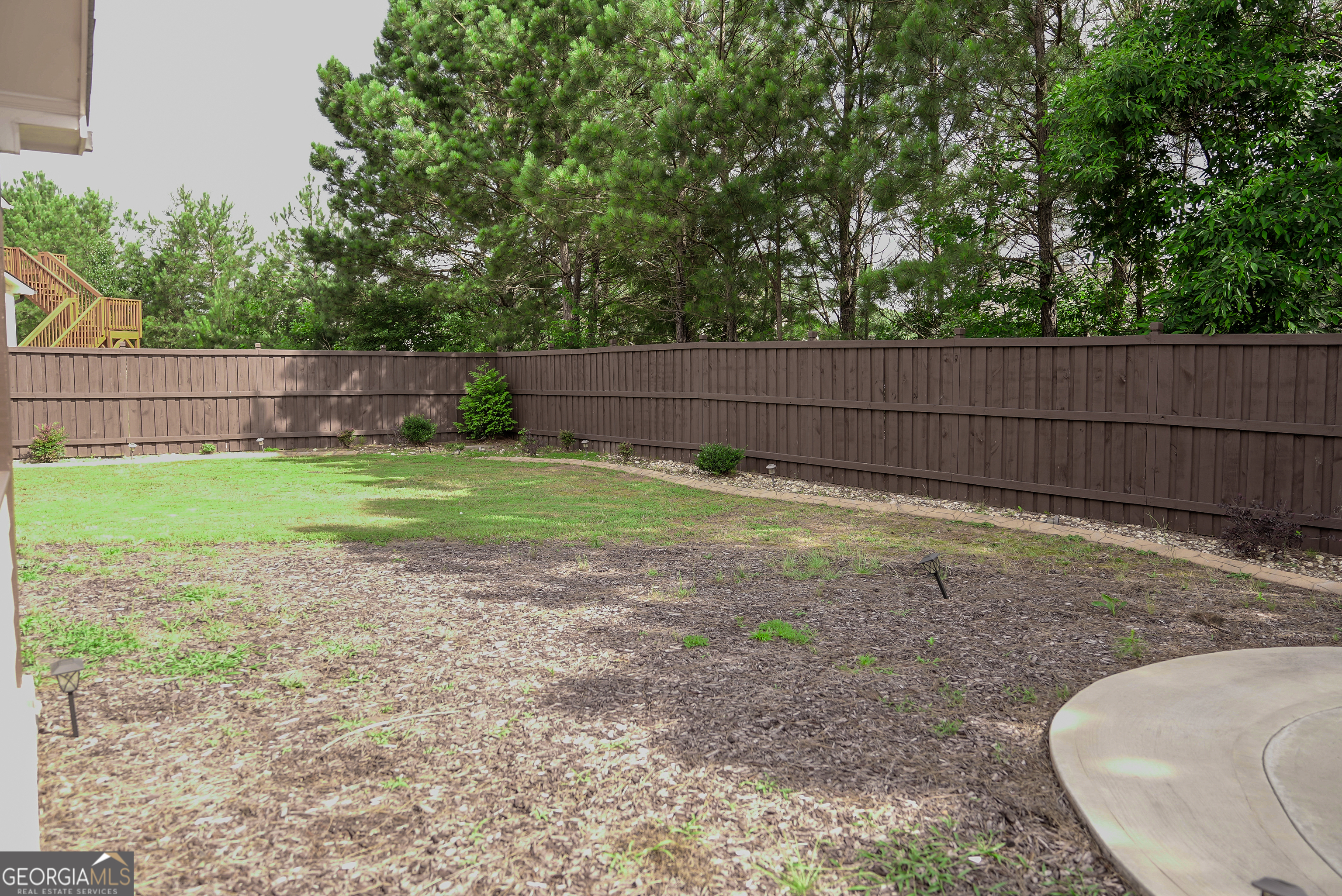 505 Mirror Lake Parkway Villa Rica, GA 30180 - Photo 28 of 28 a view of a backyard with a small cabin and wooden fence