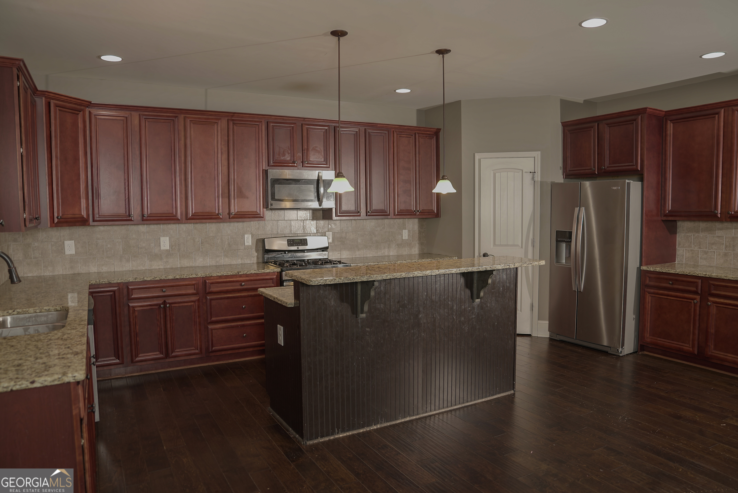 505 Mirror Lake Parkway Villa Rica, GA 30180 - Photo 6 of 28 a kitchen with kitchen island a counter top space a sink and appliances