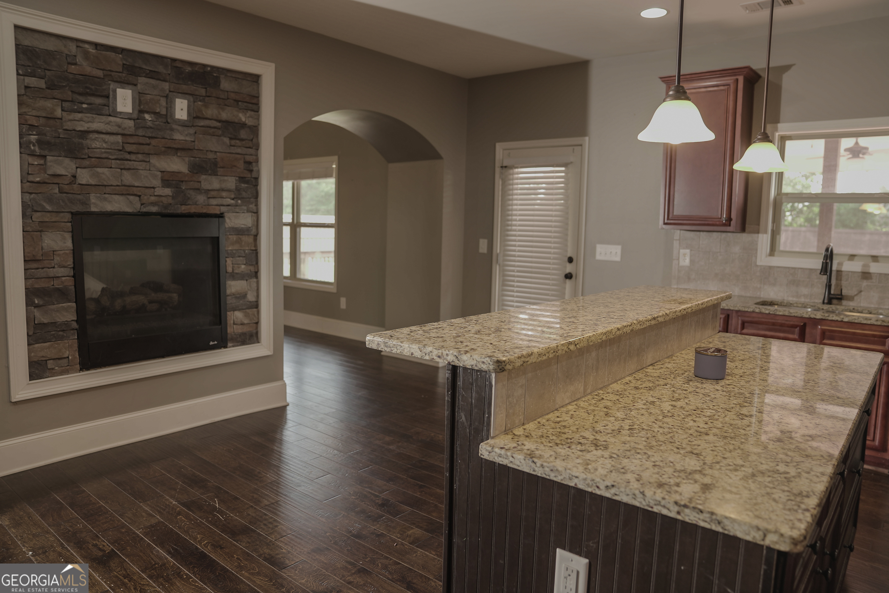 505 Mirror Lake Parkway Villa Rica, GA 30180 - Photo 7 of 28 a kitchen with kitchen island granite countertop wooden floor and a sink