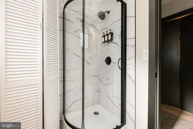 a bathroom with a glass shower door