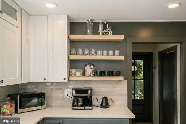 a kitchen with a oven a refrigerator and cabinets