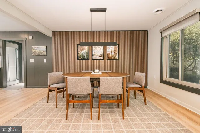 a dining room with furniture and window