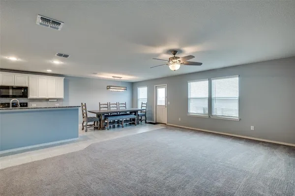 a view of a livingroom with furniture and a ceiling fan