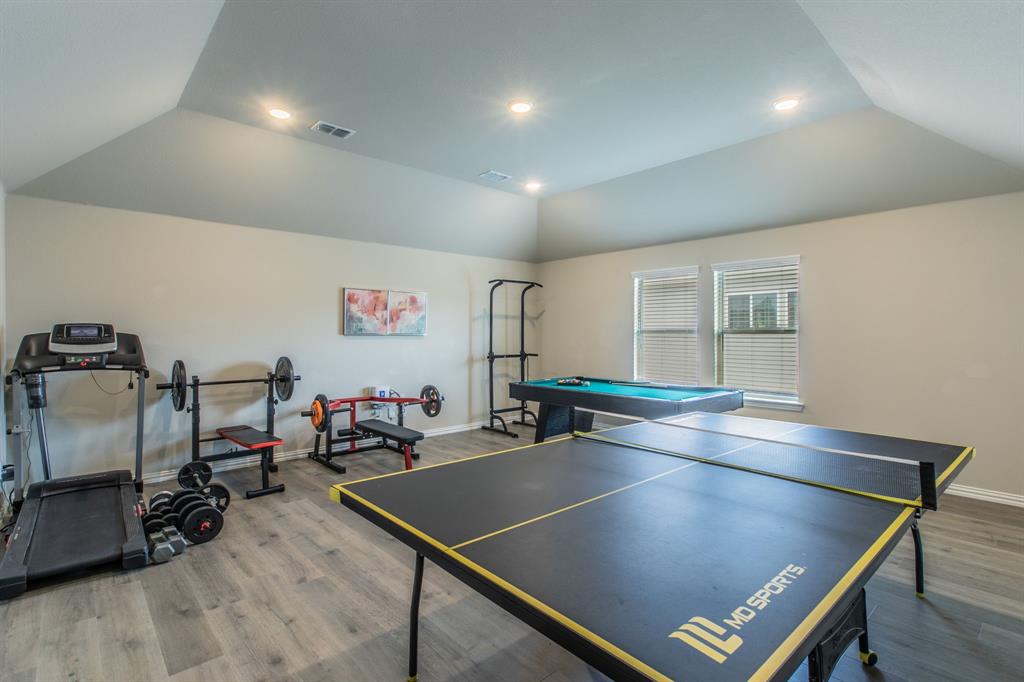 2521 Maidenhair Road Frisco, TX 75033 - Photo 26 of 39 Spacious bonus room featuring sloped ceilings with recessed lighting, wood-finish flooring, and multiple windows with blinds