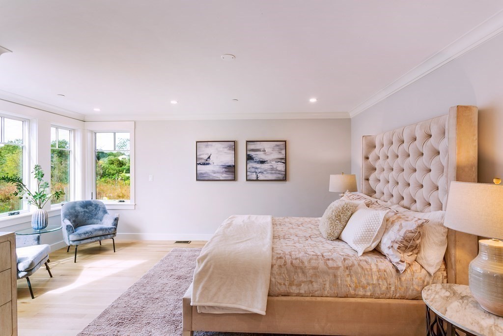 163 Atlantic Road, Unit 6 Gloucester, MA 01930 - Photo 12 of 22 a bedroom with a large bed and a couch