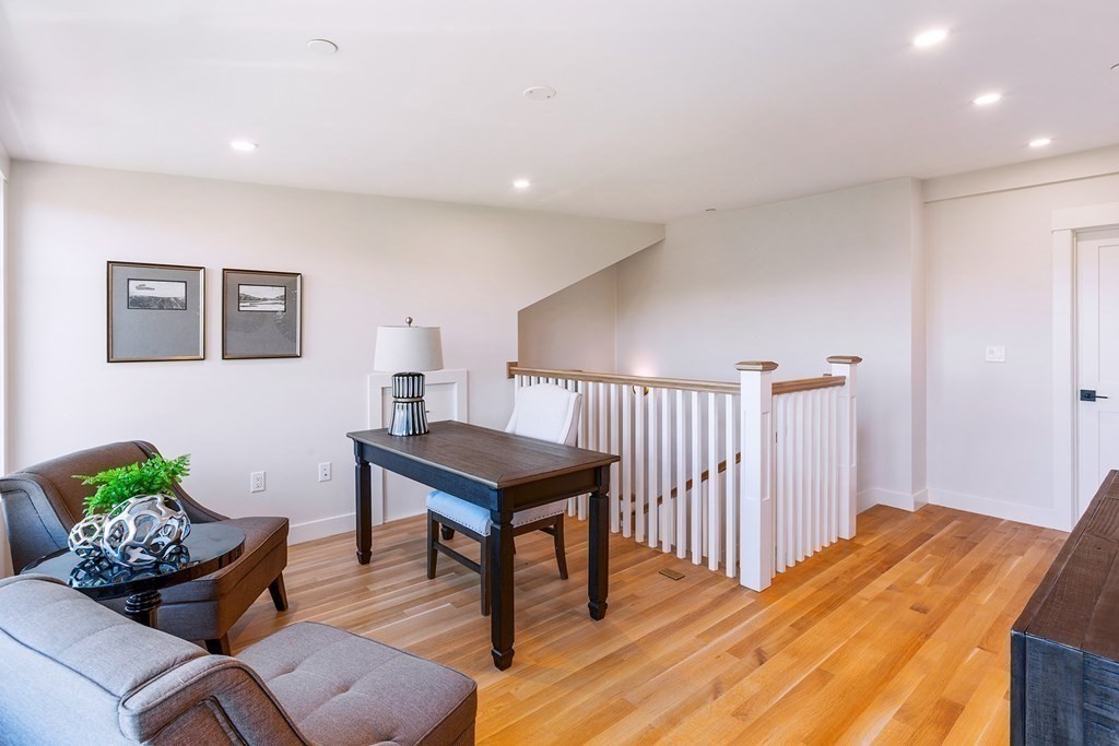 163 Atlantic Road, Unit 6 Gloucester, MA 01930 - Photo 15 of 22 a bedroom with furniture and a wooden floor