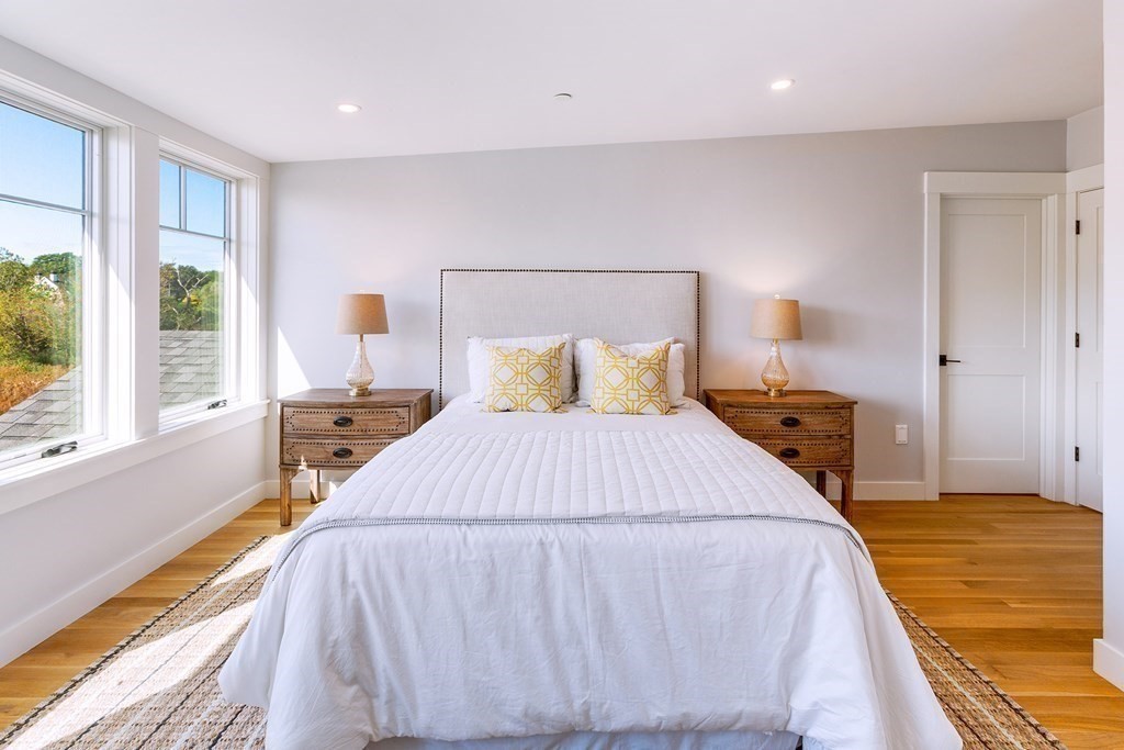 163 Atlantic Road, Unit 6 Gloucester, MA 01930 - Photo 17 of 22 a bedroom with a bed and a large window