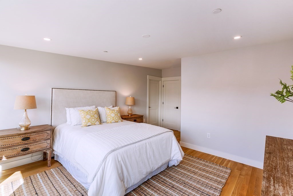 163 Atlantic Road, Unit 6 Gloucester, MA 01930 - Photo 18 of 22 a bedroom with a bed and a night stand