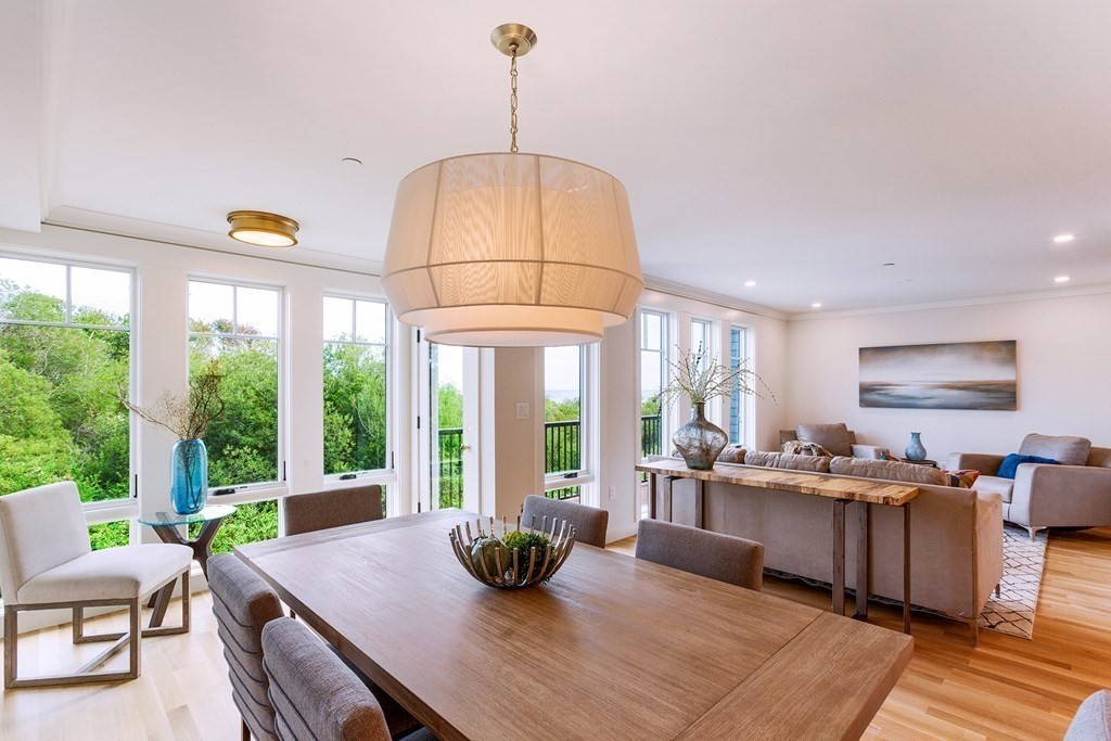 163 Atlantic Road, Unit 6 Gloucester, MA 01930 - Photo 9 of 22 a room with stainless steel appliances kitchen island granite countertop a table and chairs in it