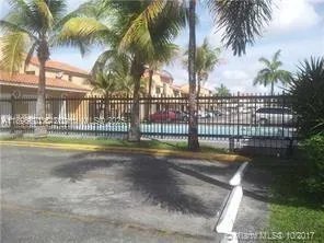 a view of swimming pool with palm trees