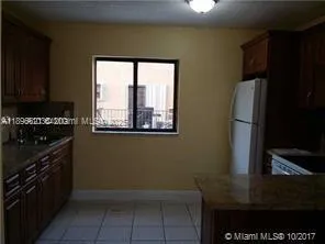 a kitchen with a sink a stove and a refrigerator