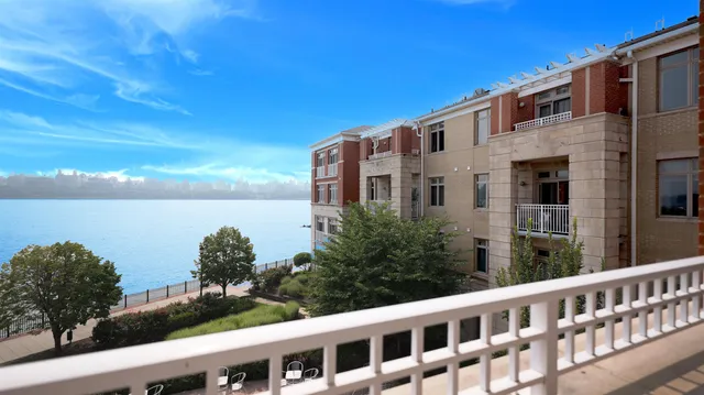 a front view of a building with lake view and mountain view