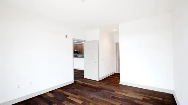 a view of a room with wooden floor