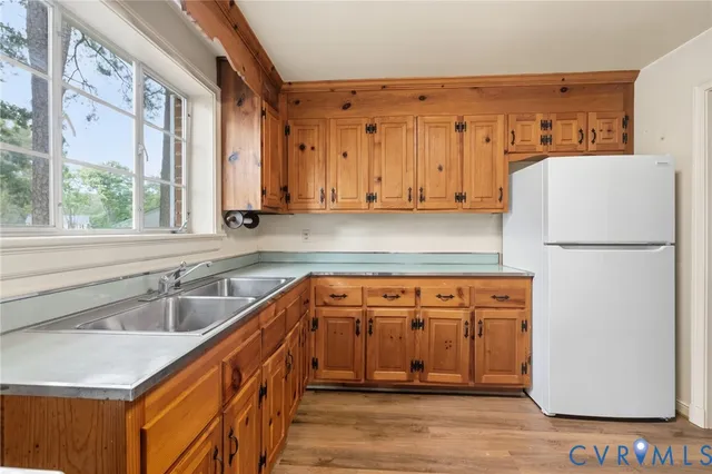 a kitchen with stainless steel appliances granite countertop a refrigerator and a sink