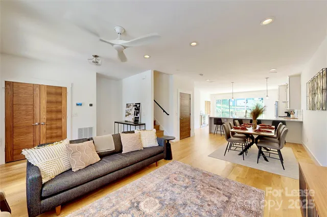 a living room with furniture dining table and a large window