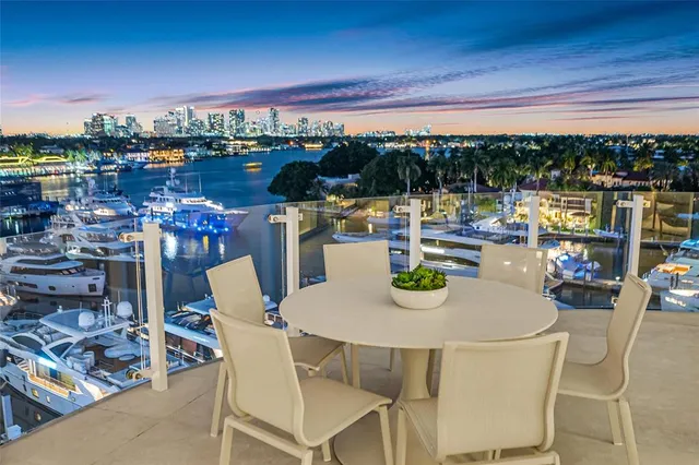 a living room with furniture a large window and kitchen view