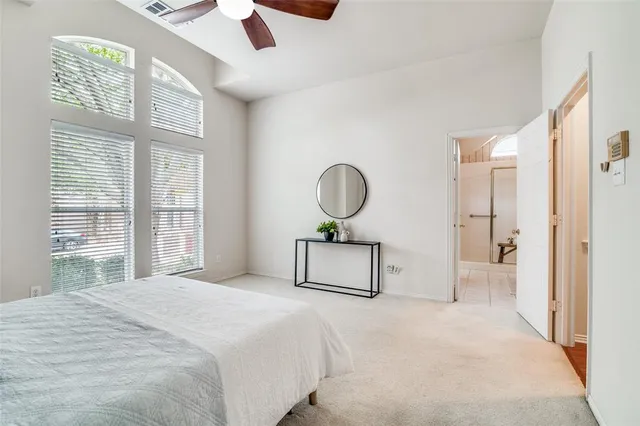 a bedroom with a bed a window and a chandelier