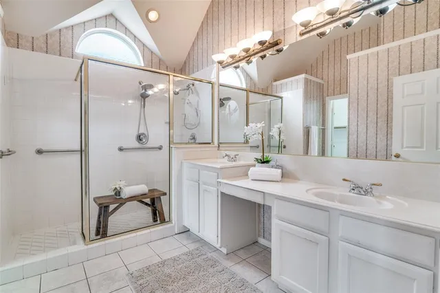 a bathroom with a sink double vanity and a mirror