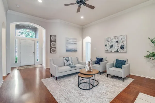 a living room with furniture and a wooden floor