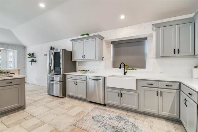 a kitchen with a sink stove and refrigerator