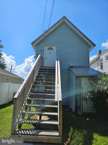 a front view of a house with plants