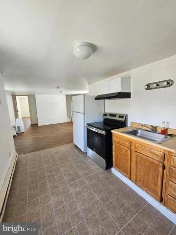 a kitchen with granite countertop a sink and cabinets