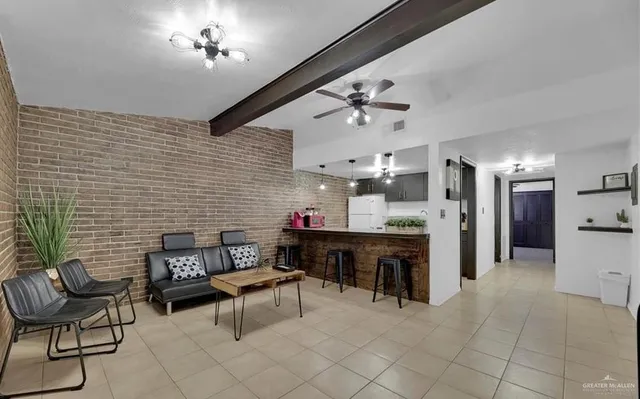 a view of a livingroom with furniture and a kitchen