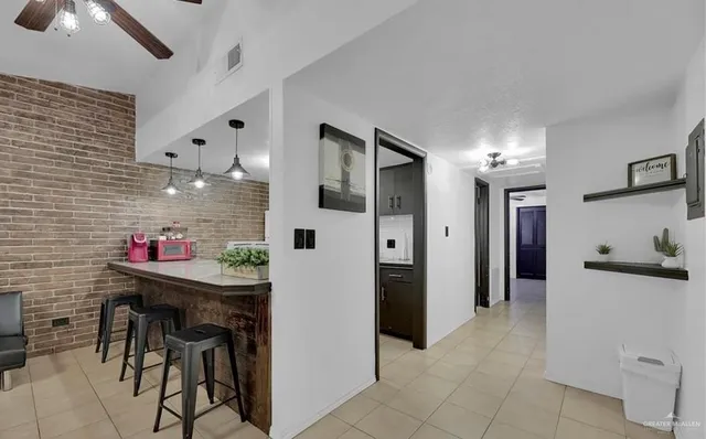a kitchen with stainless steel appliances kitchen island granite countertop a refrigerator and a sink