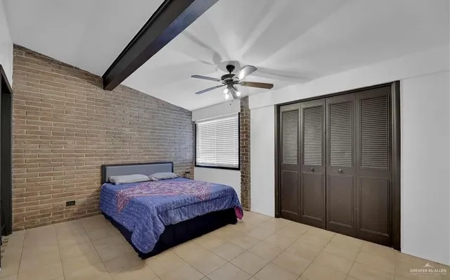 a bedroom with a bed and a ceiling fan