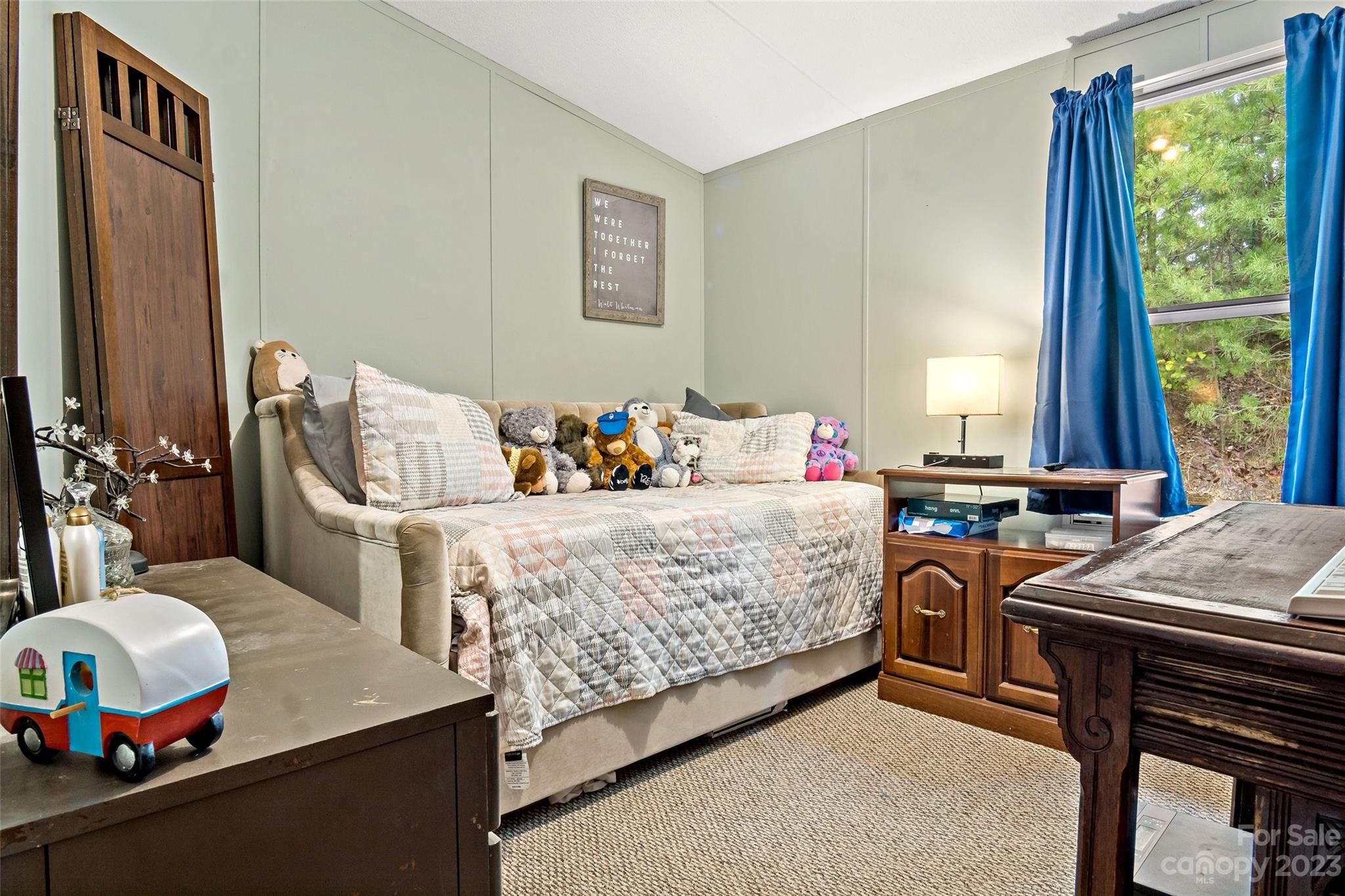 584 Ebenezer Road Old Fort, NC 28762 - Photo 17 of 41 a bedroom with a bed and a table in it