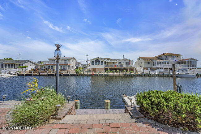 835 Anchor Drive Forked River, NJ 08731 - Photo 105 of 146 a view of a lake with boats and trees in the background