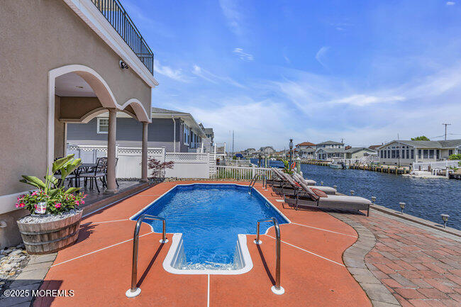 835 Anchor Drive Forked River, NJ 08731 - Photo 118 of 146 a view of a swimming pool with a lounge chairs