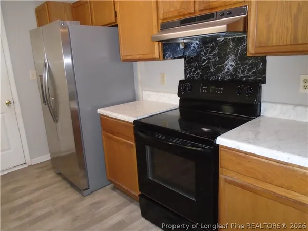 a stove top oven sitting inside of a kitchen