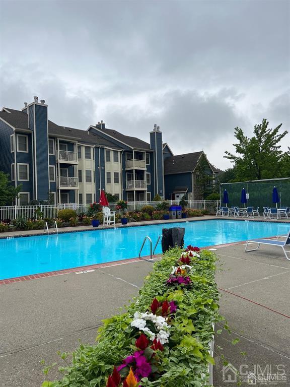 a view of swimming pool with outdoor seating and plants