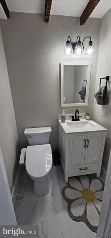 a bathroom with a toilet sink and mirror