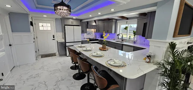 a view of a kitchen area with furniture and chandelier