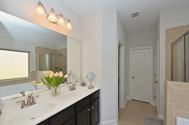 a bathroom with a sink vanity granite and a mirror