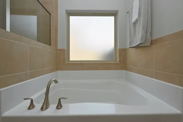 a white bath tub sitting next to a window