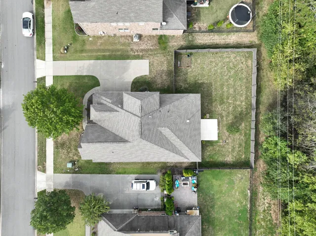 an aerial view of a house with garden space and sitting area